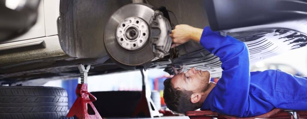 automotive service bay brake pad replacement professional technician modern equipment